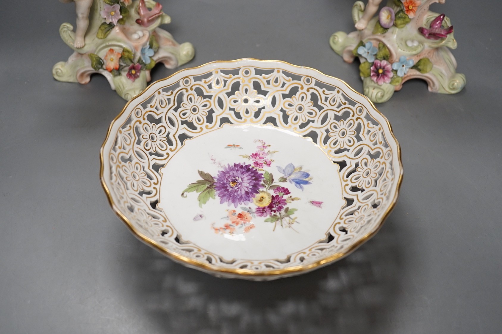 A Meissen flower painted pierced dish and two German porcelain candlesticks - 25.5cm tall